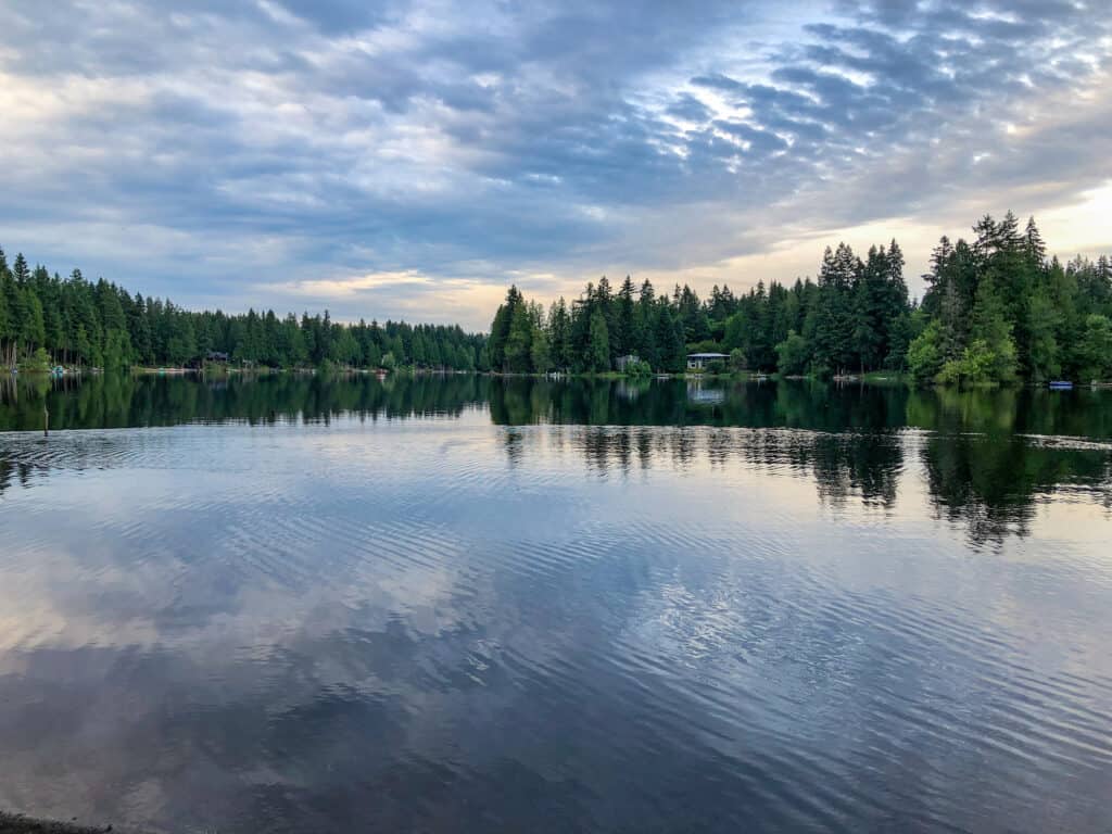 Clouds reflect on the still surface of Beaver Lake, a great fishing spot in Sammamish.