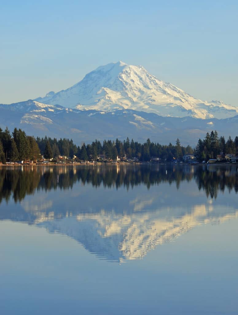 A scenic view of mount Rainier reflecting on the surface of Lake Tapps.