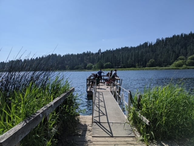 anglers fishing from a dock at fish lake