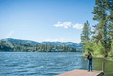 Angler casting from a dock at Curlew Lake State Park