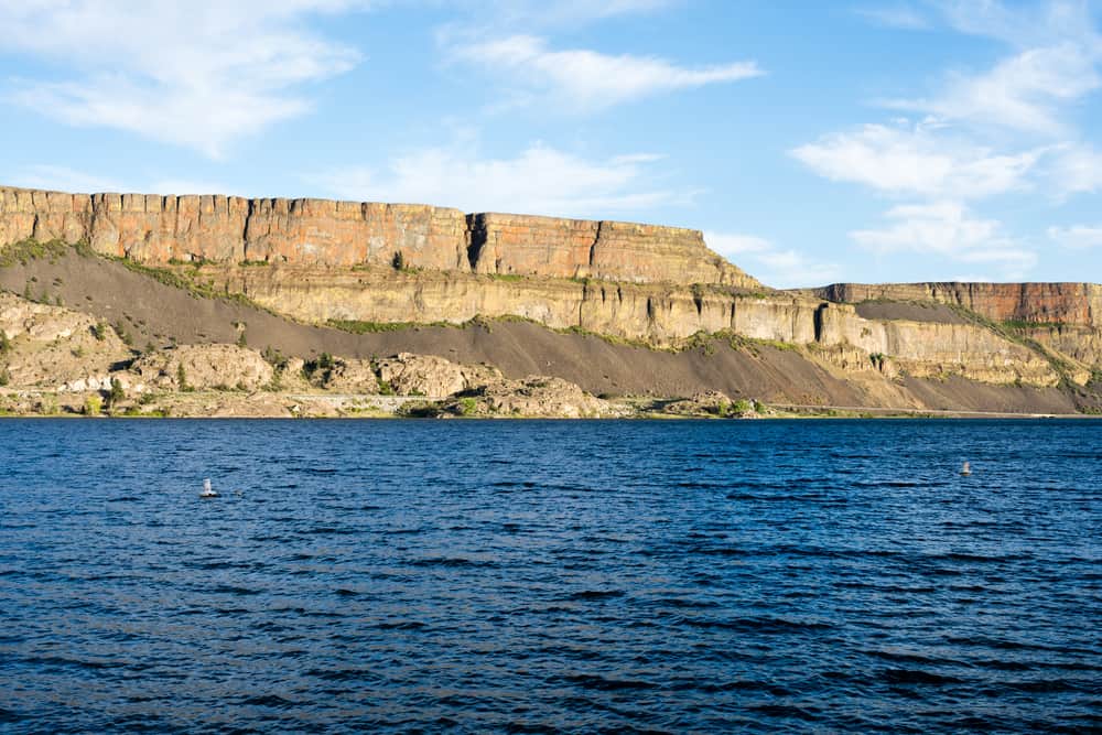 A scenic view of cliffs rising above banks lake, central washington.