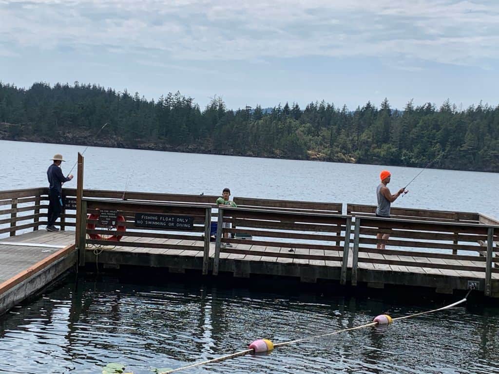 Anglers fishing for trout and other fish from the dock at Cascade Lake