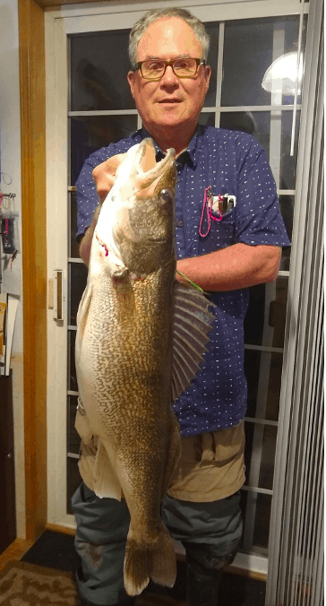 Angler in his house holding a very large walleye caught at Moses Lake, Washington.