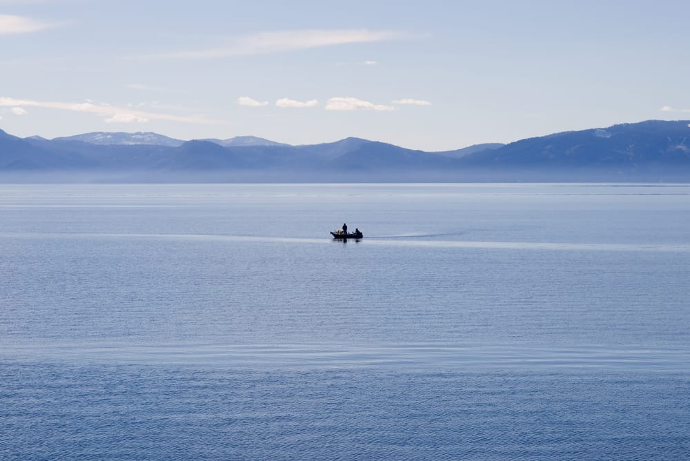 A fishing boat plies the waters of Lake Tahoe, known for kokanee salmon and trout fishing.