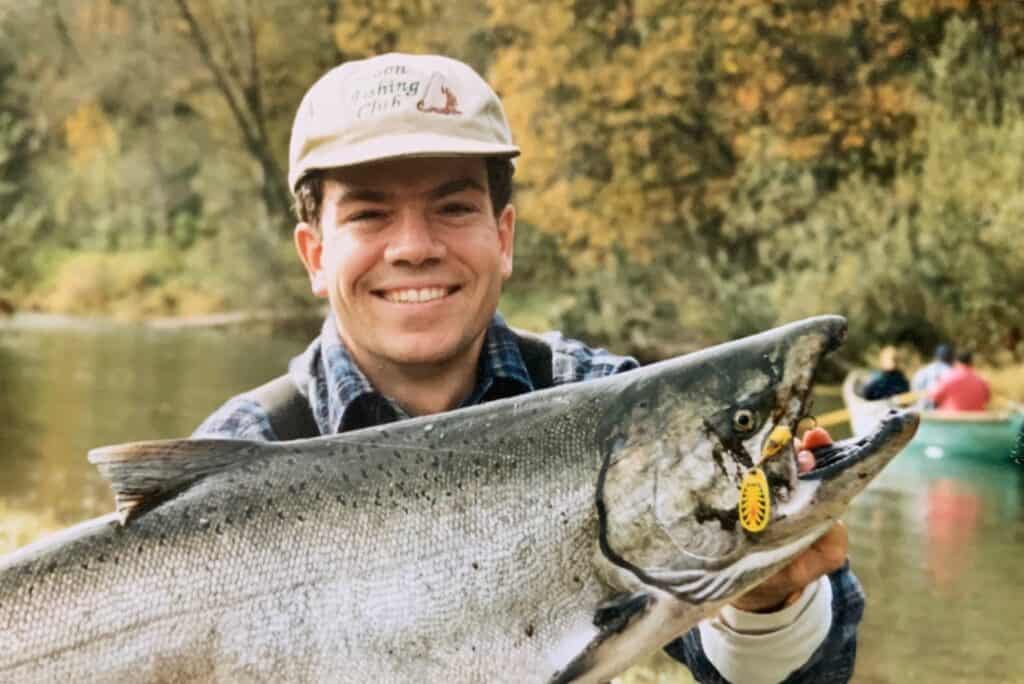 The publisher holding a large Chinook salmon he caught.