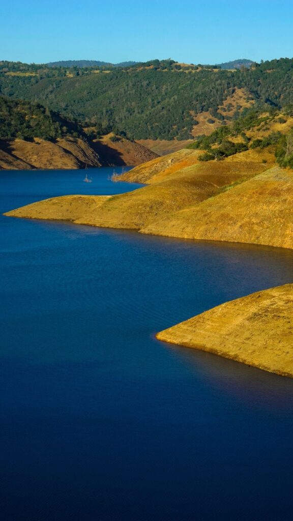 The blue water of New Melones Lake in contrast to bare shorelines.