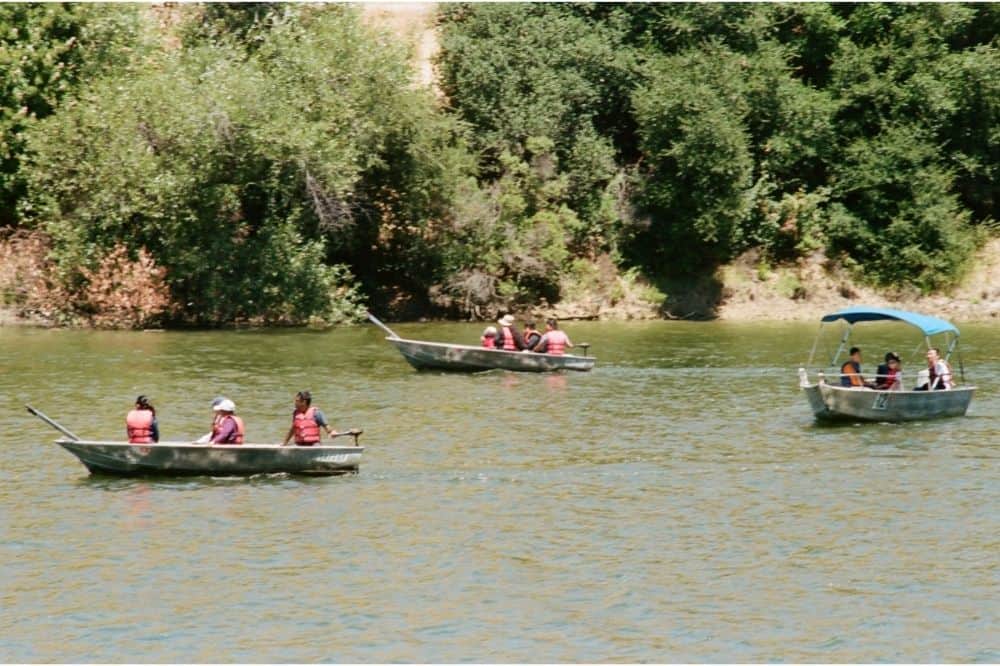 Three boats with electric motors cruise by on Lake Chabot, a Bay Area lake known for fishing.