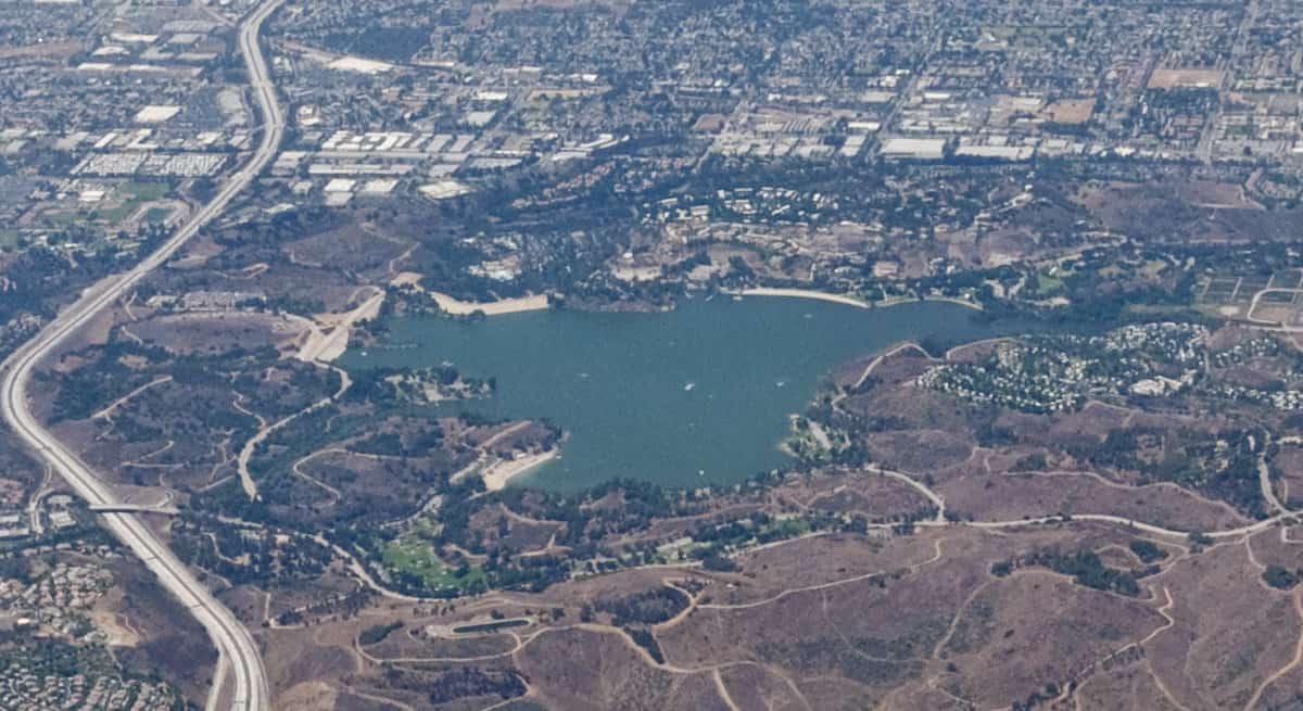 Aerial view of the entire Puddingstone Lake with open and developed land in San Dimas surrounding it.