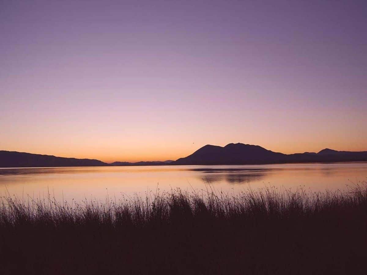 Sunset offers up purple and orange hues reflecting on the surface of Clear Lake.