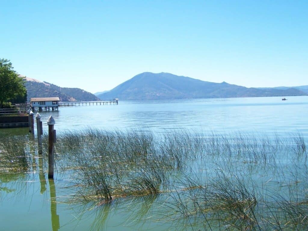 A fishing boat approaches a pier on Clear Lake, California.