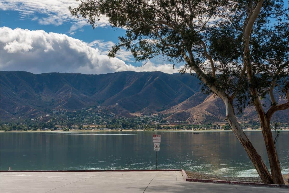 Scenic view from the shore of Lake Elsinore with Santa Ana Mountains in distance.