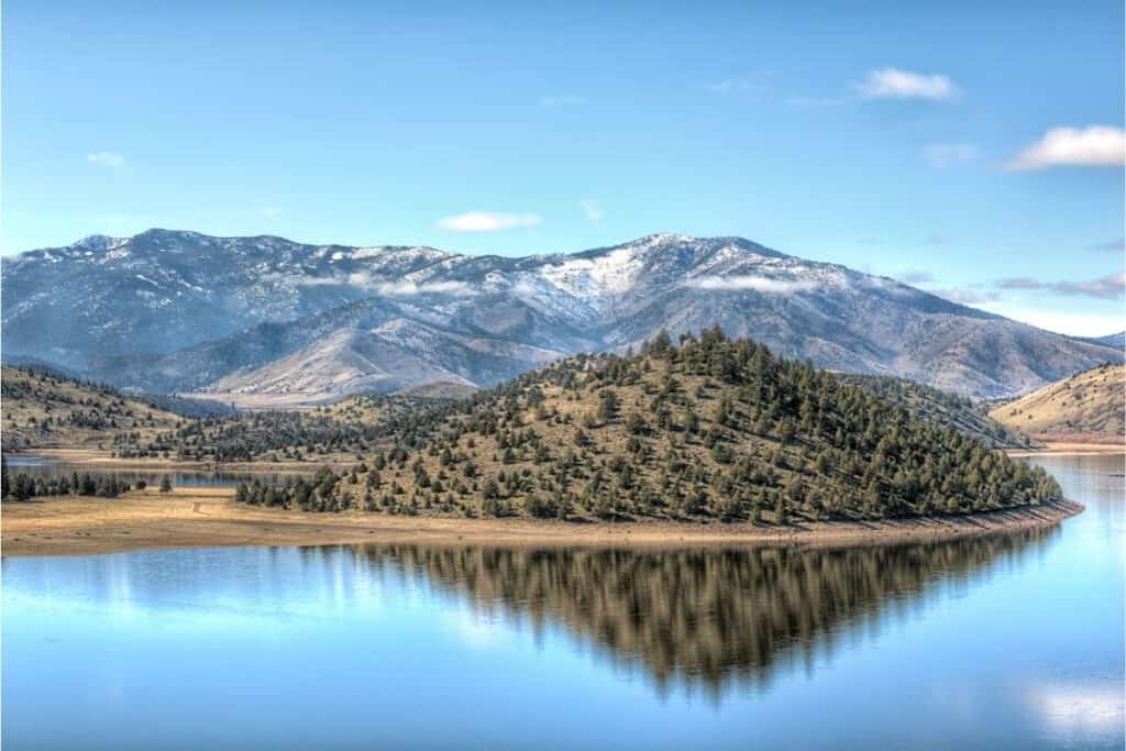 Scenic view of Lake Shastina with snow tinted mountains in the background.