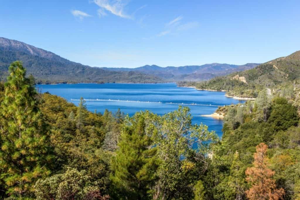 Whiskeytown Lake is a vibrant blue under sunny skies.