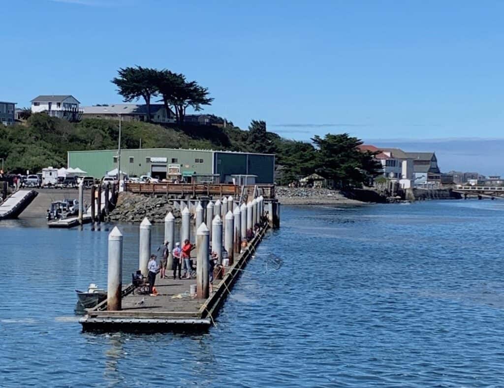 People try to catch Dungeness crabs from the dock in Bandon, Oregon.