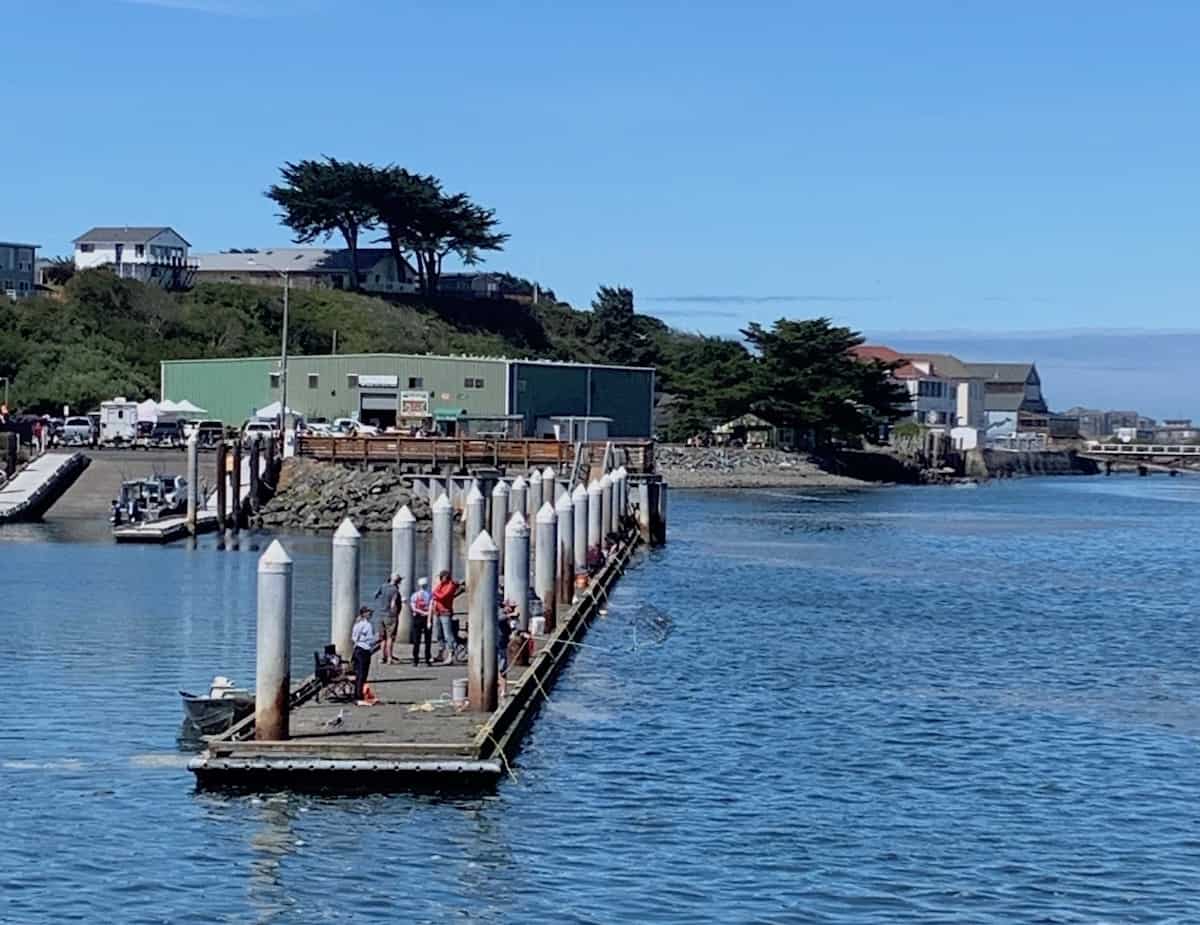 People crabbing from docks in Bandon, Oregon.