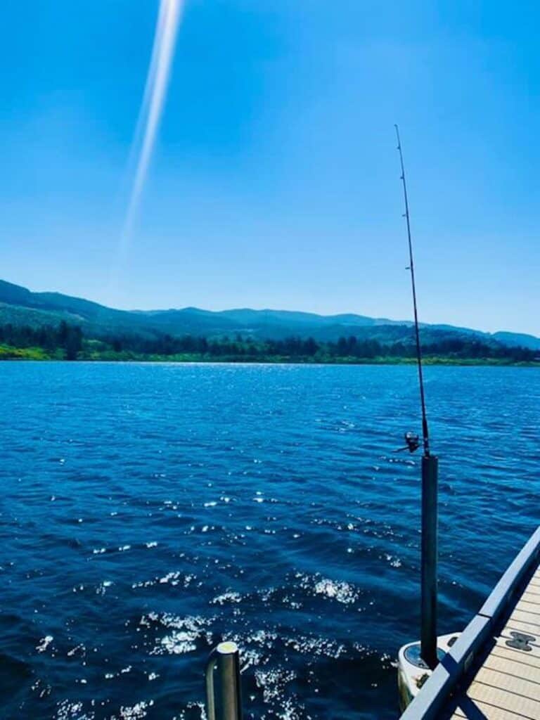 An angler's fishing pole with the line in the water awaits a bite at Lake Lytle.