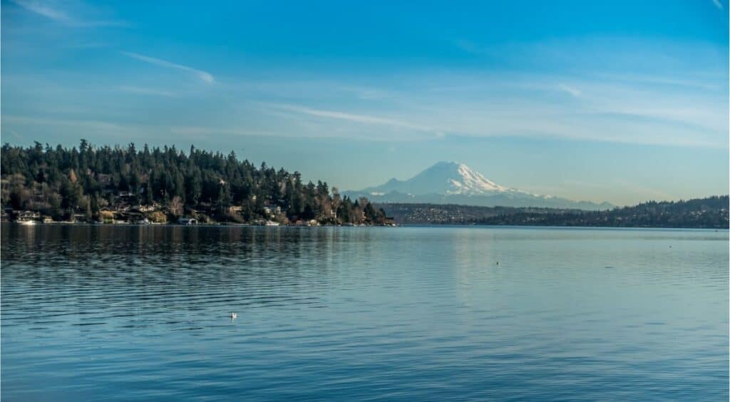 Mount Rainier rises beyond the surface of Lake Washington near Seattle.