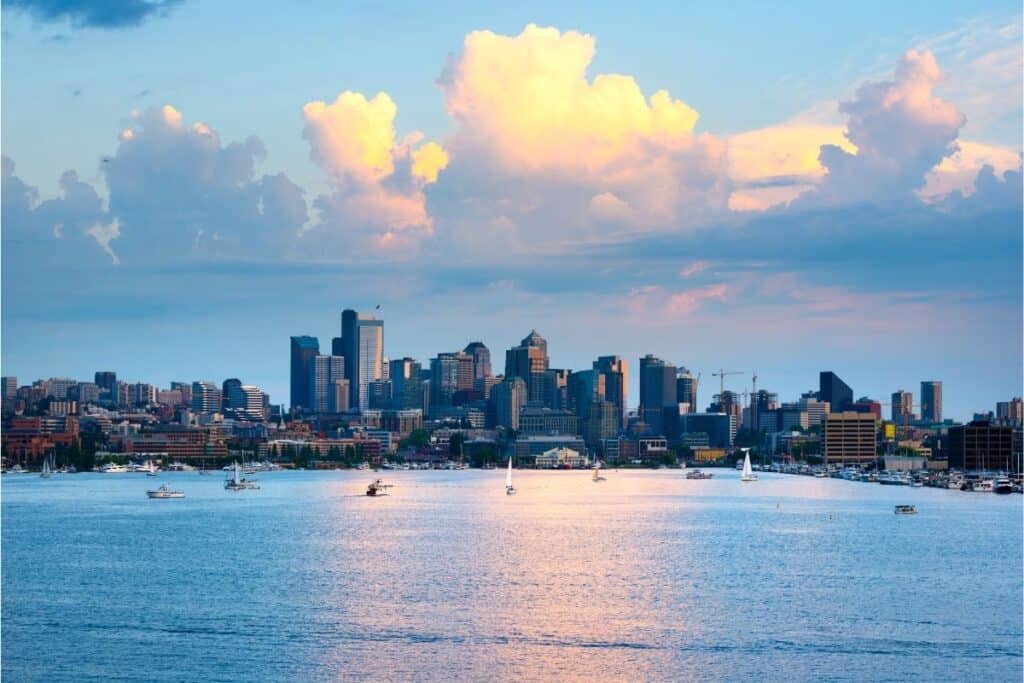 Clouds billow over boats on the surface of Lake Washington with Seattle as a backdrop.