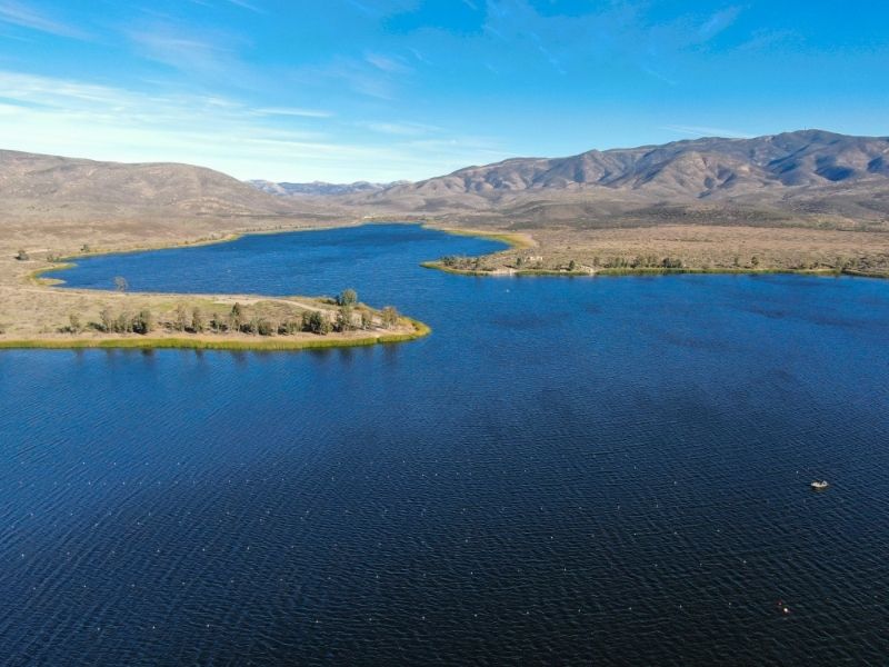 Lower Otay Lake with a fishing boat on blue water.