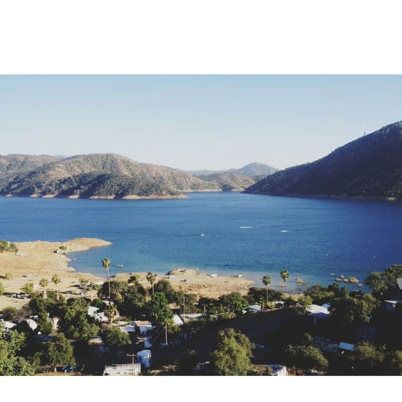 Scenic view of Pine Flat Lake with fishing boats on the blue water.