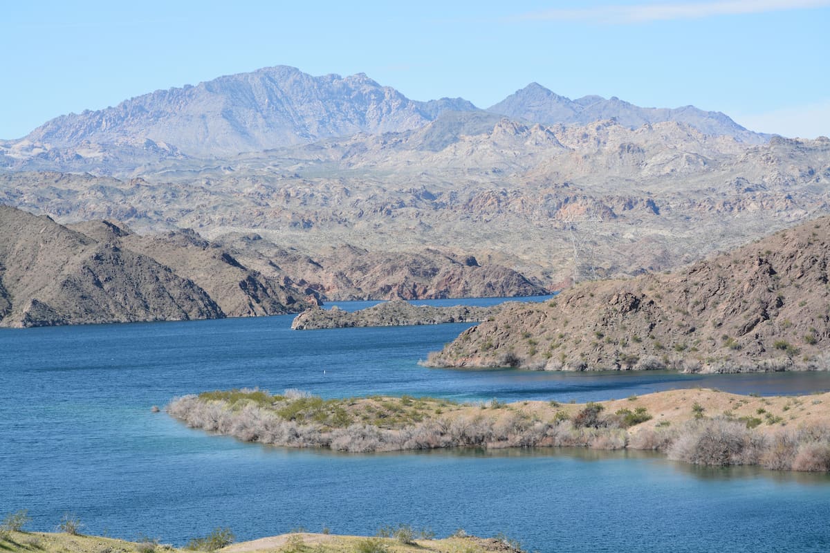 A point of land juts out into the blue waters of Lake Mohave on the Arizona-Nevada border.
