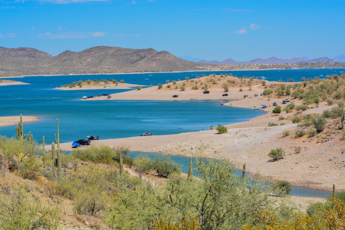 Scenic landscape of the blue waters of Lake Pleasant and tan sands of the shoreline at this popular fishing lake near Phoenix.