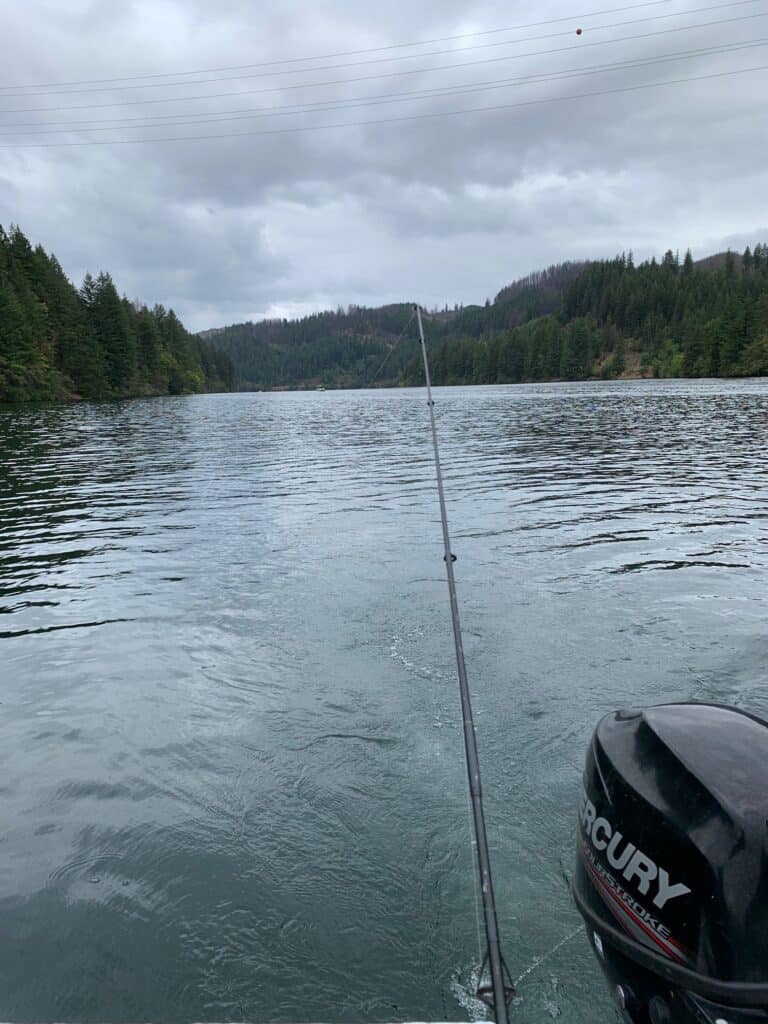A fishing rod at the back of boat, trolling for rainbow trout at North Fork Reservoir.