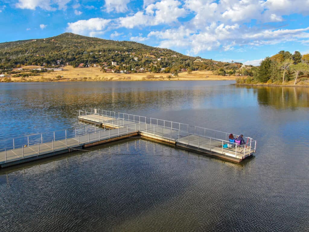 People fishing from a pier at Lake Cuyamaca.