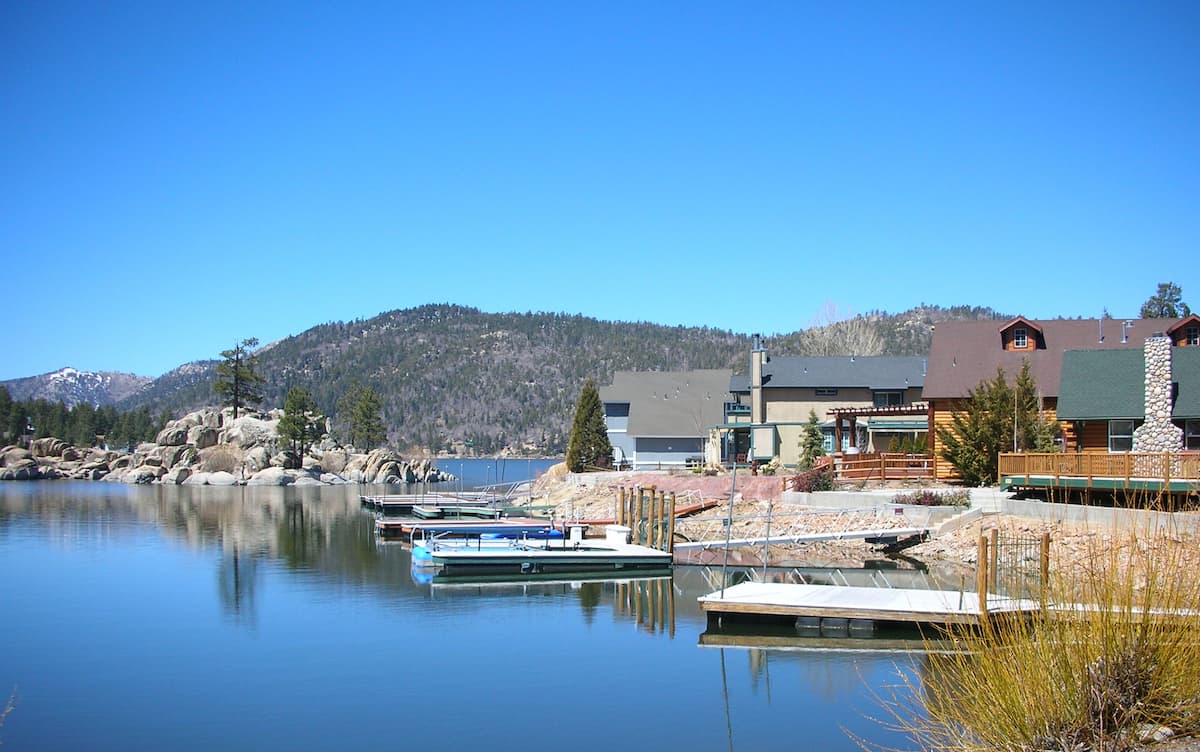 Fishing boats docked near homes on the shore of Big Bear Lake.