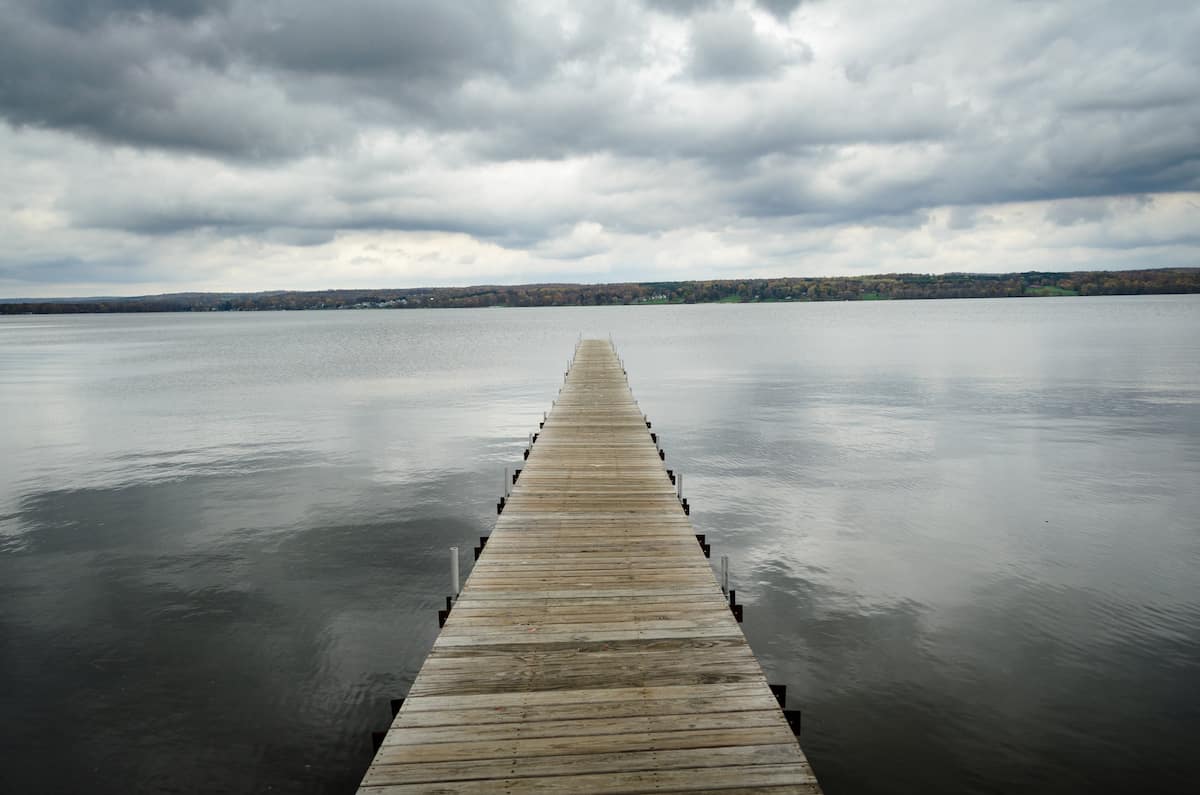 A dock stretches out across the calm surface of Chautauqua Lake.