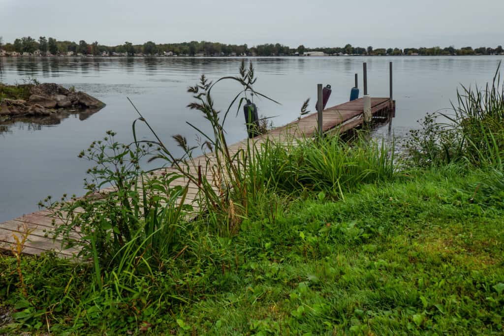 Old, weathered pier on Oneida Lake in Cicero, New York on an overcast autumn morning.