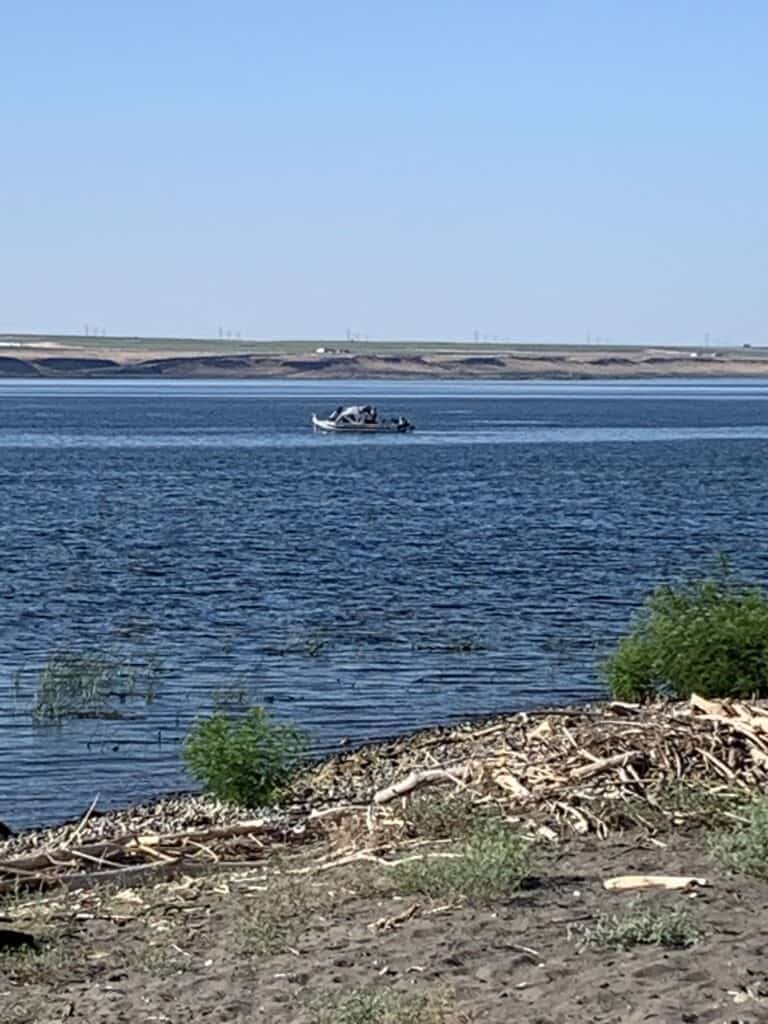 A fishing boat trolls through the Columbia River off the bank of Boardman, Oregon.