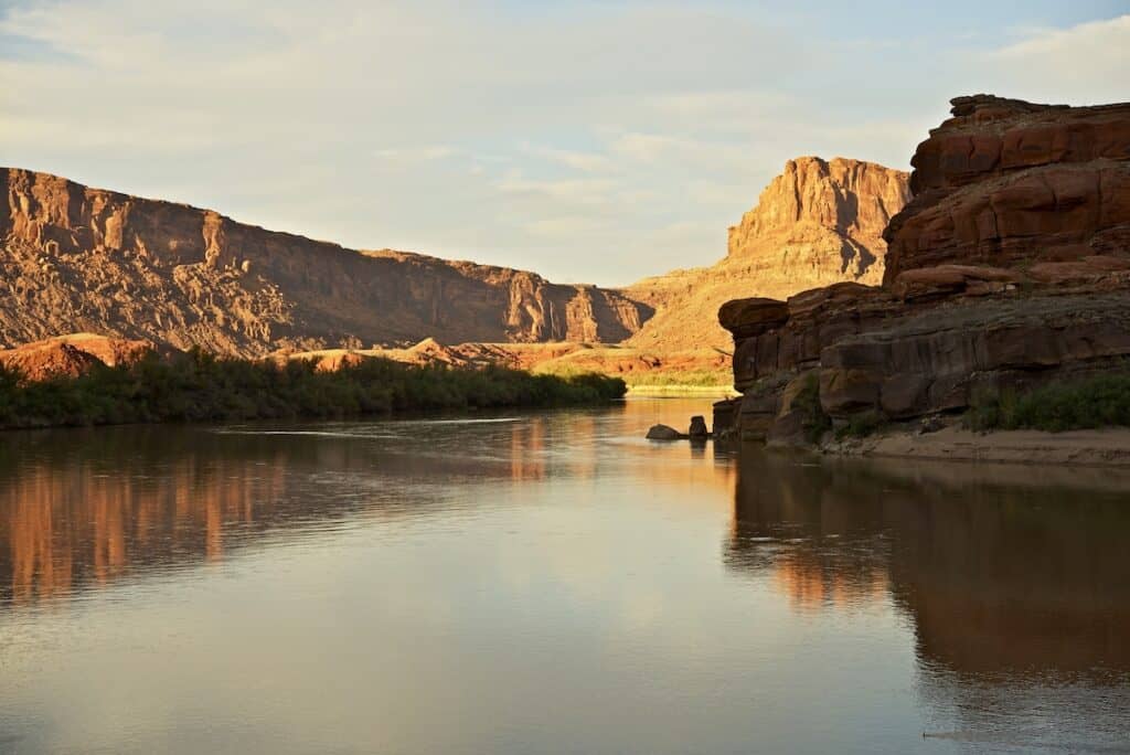 Shadows fall on canyon walls and the slowly flowing Colorado River, which is excellent for catfish fishing in the evenings.