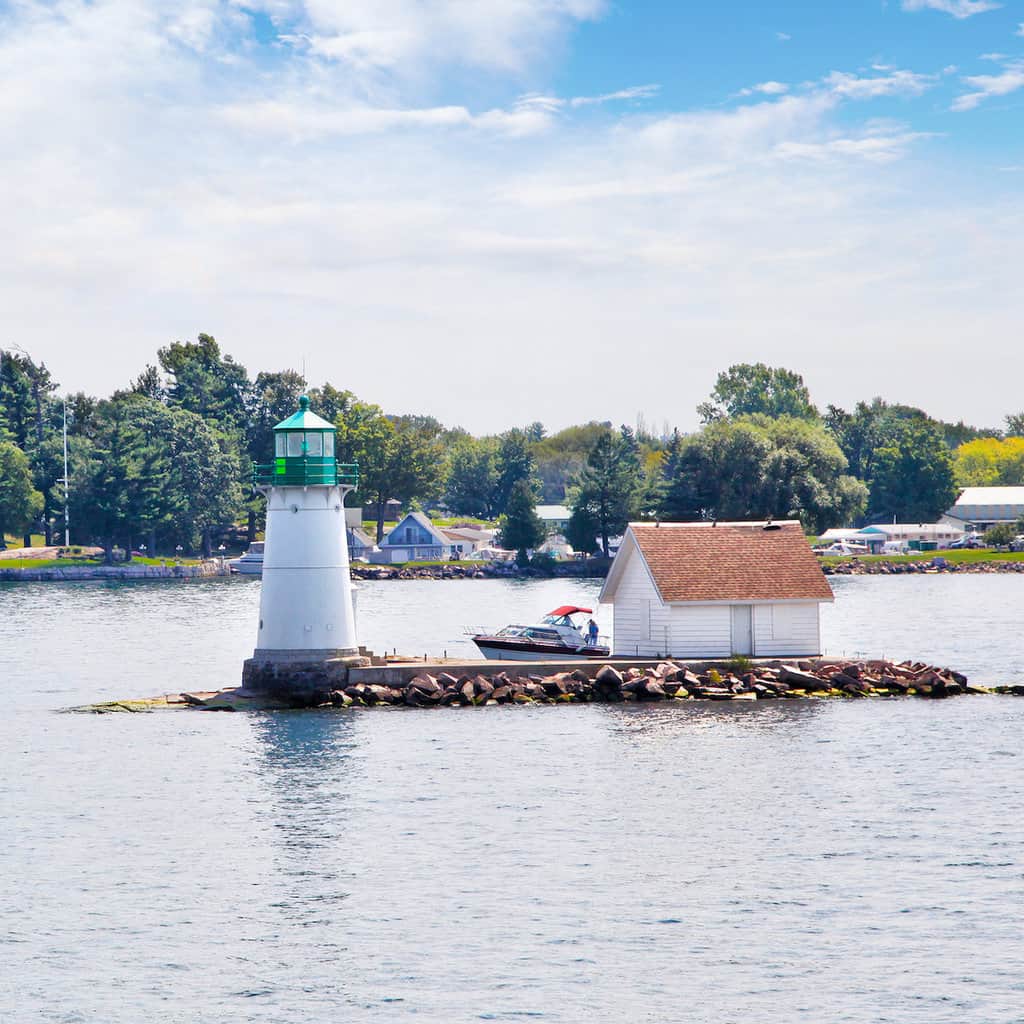 A lighthouse on a tiny rock island in the Thousand Islands area of the St. Lawrence River.