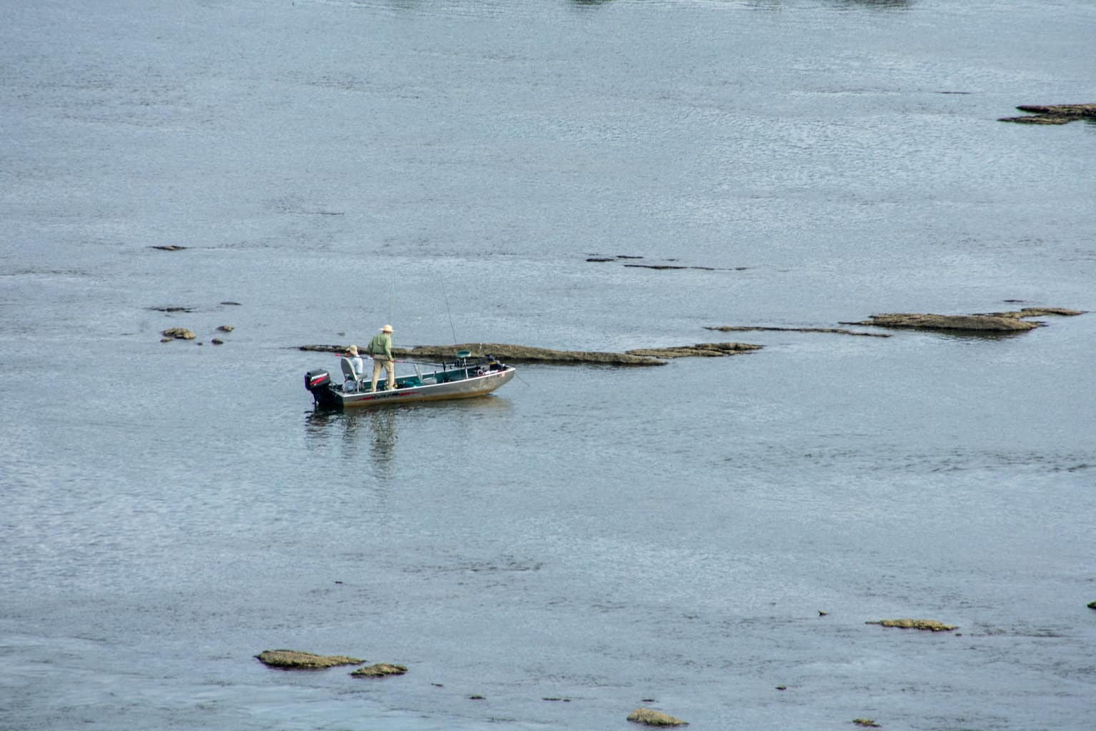 Two people fishing in a small boat on the Susquehanna River in Pennsylvania.