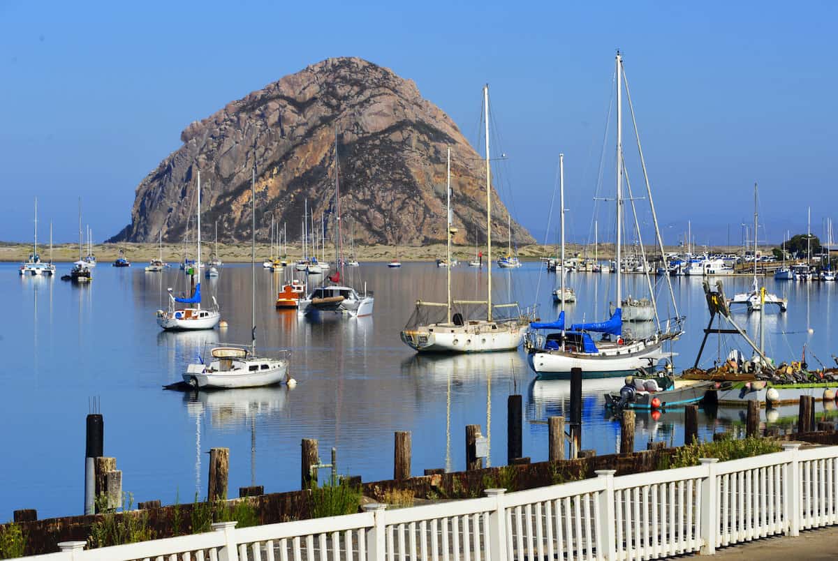 With the Rock in the background, boats sit in Morro Bay Harbor, a popular place to begin fishing trips.