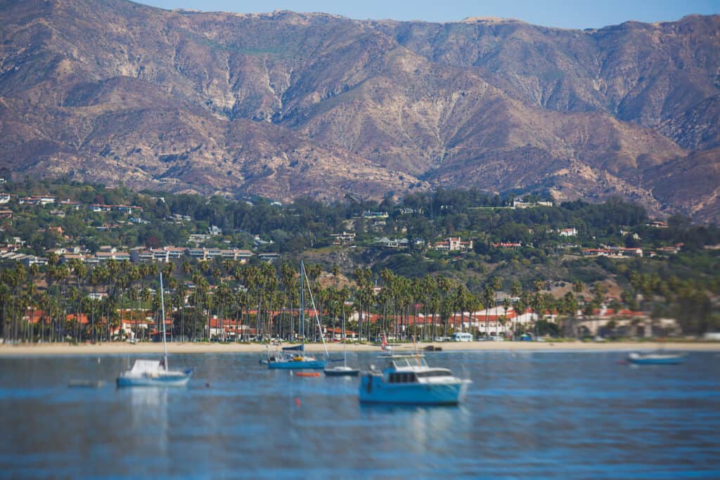 Beautiful view of Santa Barbara ocean with boats on the water and Santa Ynez mountains in the background.