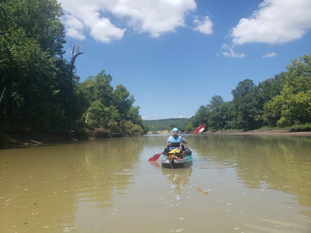A solo kayaker paddles on the Lower Illinois River in Oklahoma.