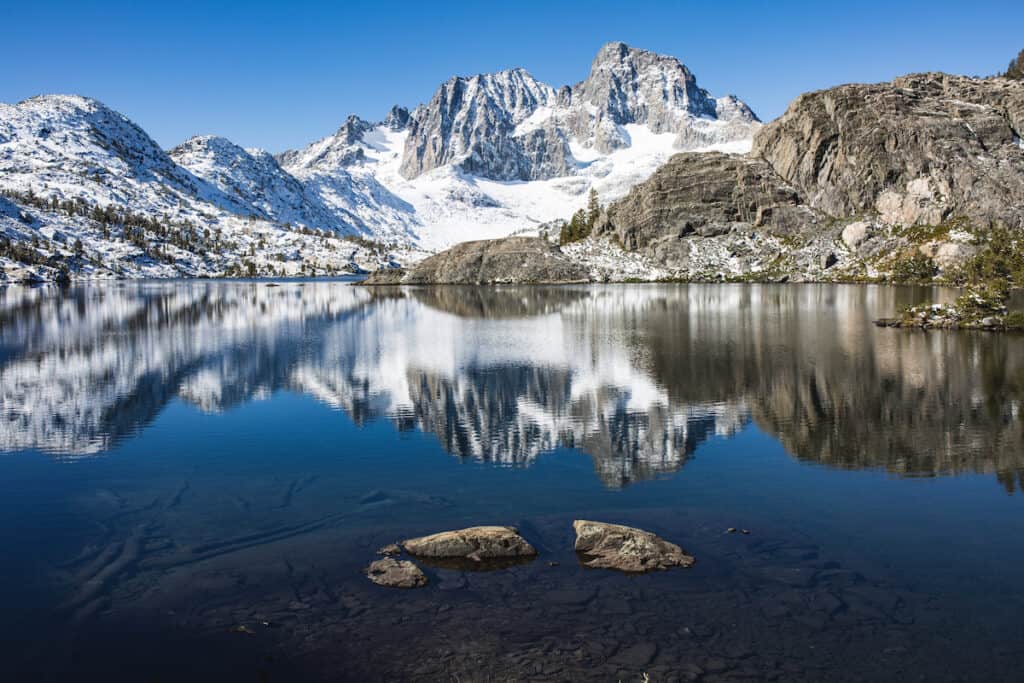 Sunrise on Banner Peak above Garnet Lake in the Ansel Adams wilderness after a fresh snow.