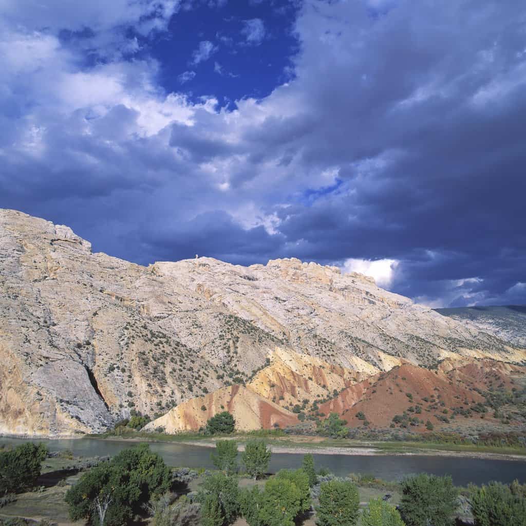 The Yampa River flowing through western Colorado, where the catfish fishing is very good, with dramatic mountains behind.