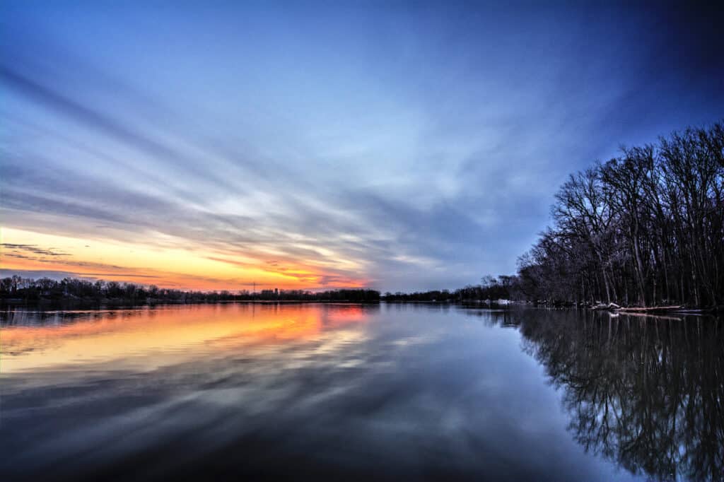 Colorful sunset on the still waters of the Maumee River, a great time and place to catch smallmouth bass.