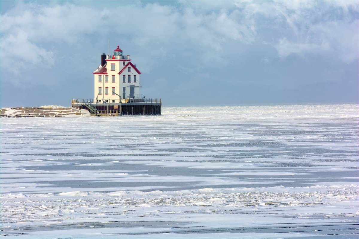 The Lorain Lighthouse along the frozen surface of Lake Erie, one of the best ice fishing spots in Ohio.