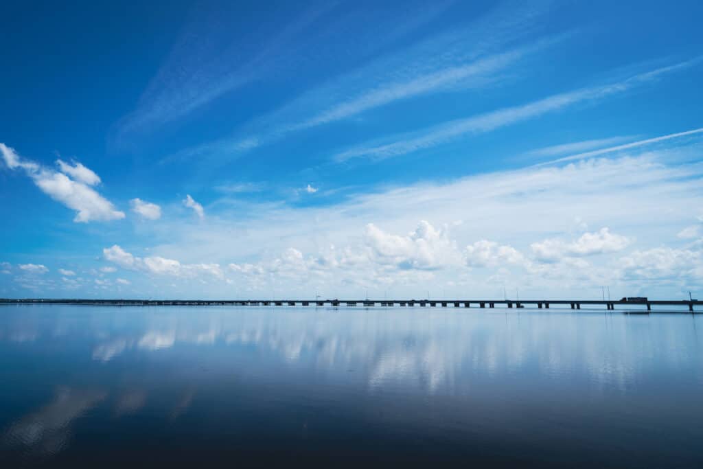 A bridge stretches across the quiet surface of Lake Jesup.