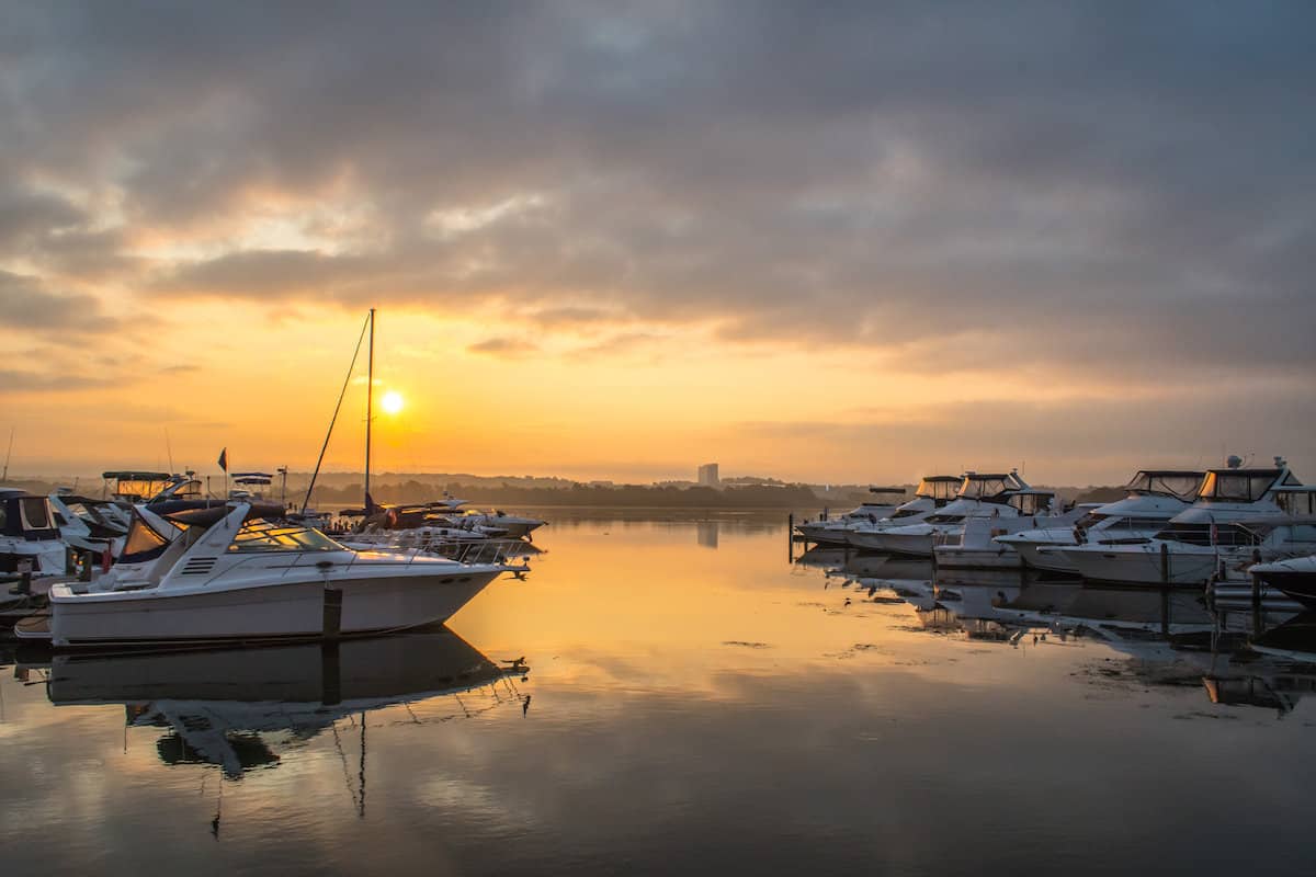 Sun setting over boats on the calm water of the Potomac River in Virginia.