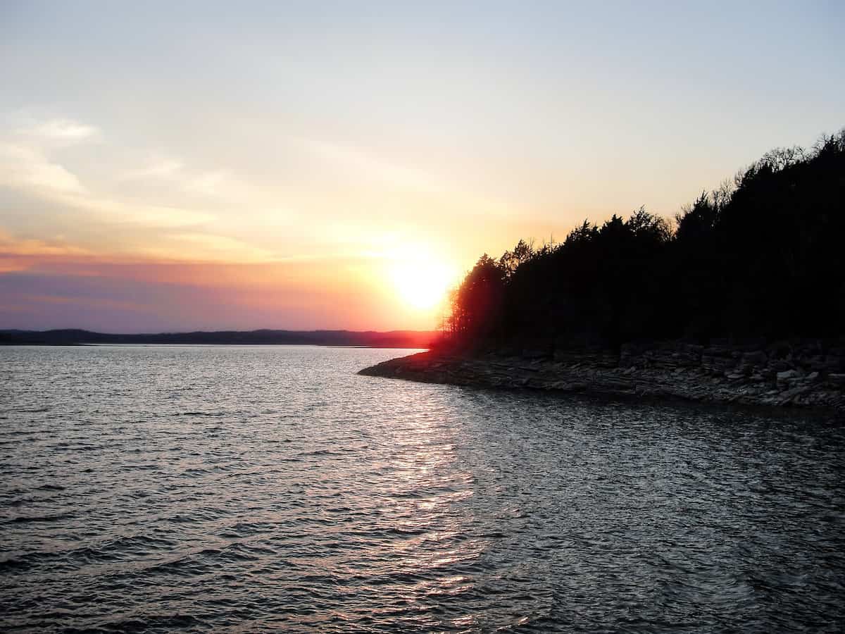 Sunset over Beaver Lake, one of the best bass fishing lakes in Arkansas.