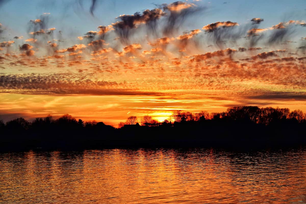 Brilliant orange sunset over Morse Lake near Cicero, Indiana.