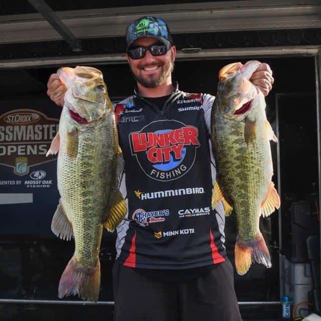 Tournament bass angler Alex Wetherell holds two giant largemouth bass he caught during a Bassmaster event on the James River in Virginia.