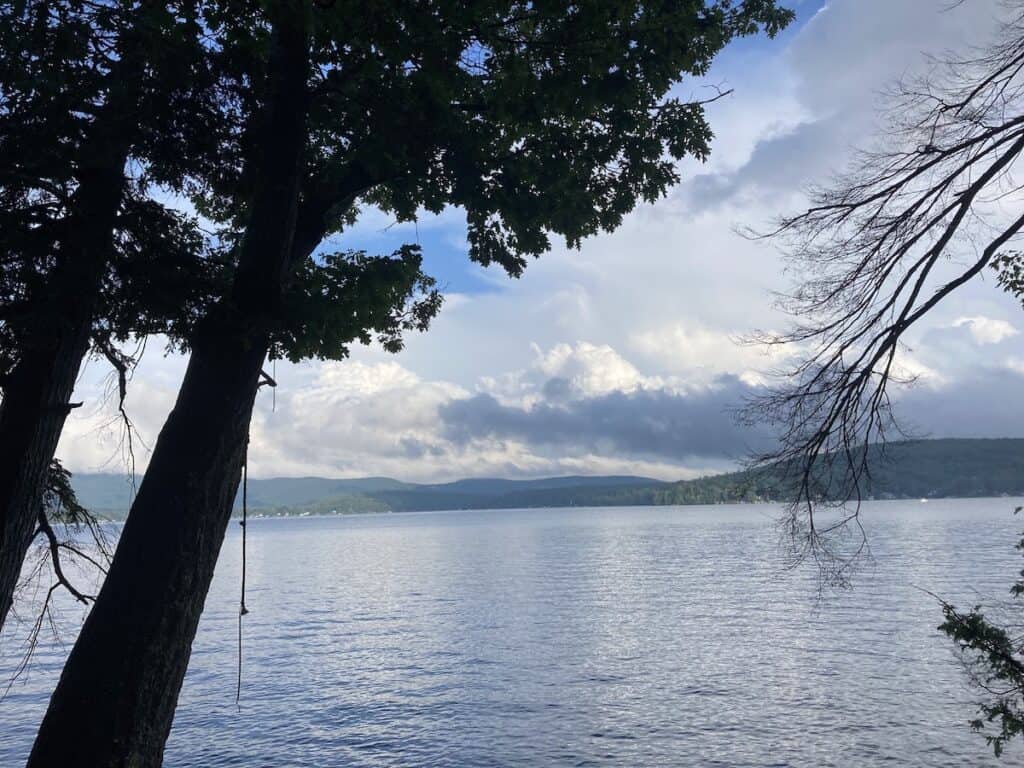 A rope hanging from a tree framing a tranquil scene looking out of Lake George in New York.