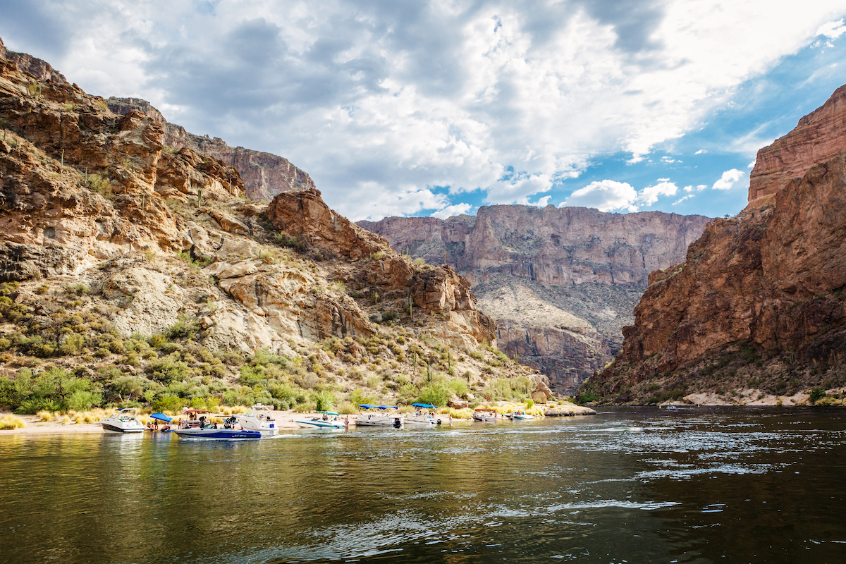 Boats beached on the shore of Canyon Lake , a good fishing spot not far from Mesa, Arizona.