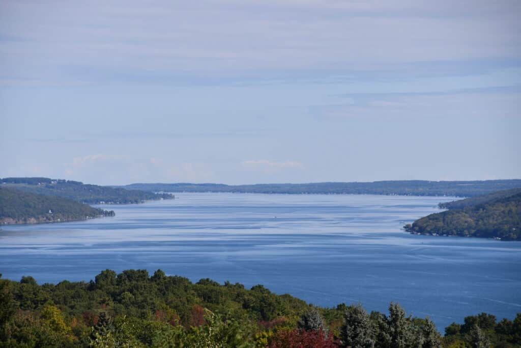 Scenic view overlooking the blue waters and forested shores of Canandaigua Lake.